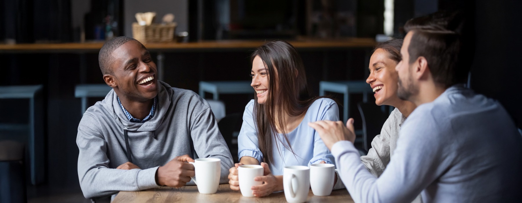 a group of friends laughing over coffee